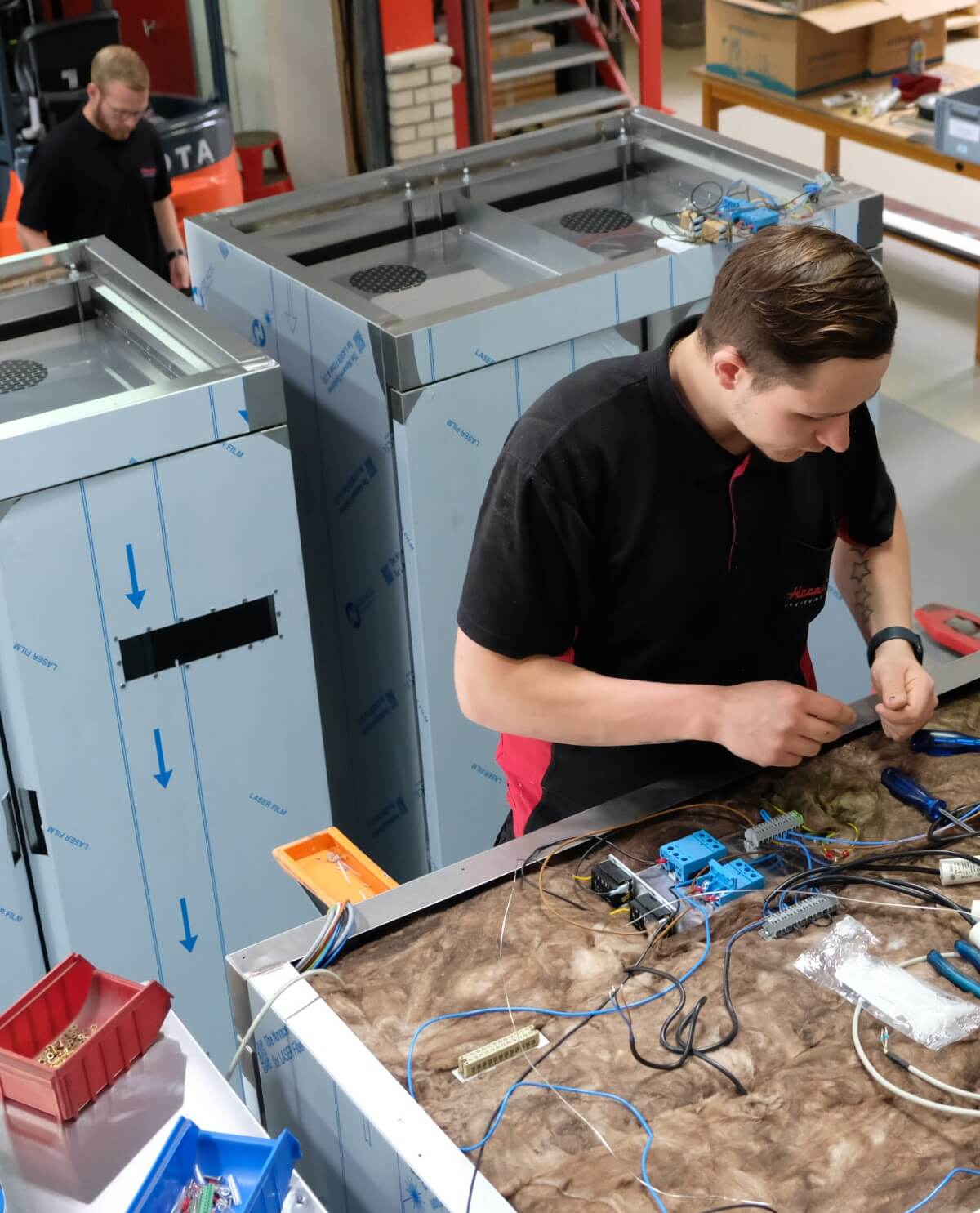 Harstra Employee working on one of our machines